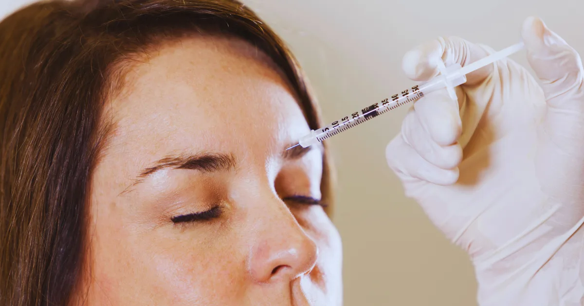 Patient receiving botulinum toxin therapy injection on the forehead or Botox by Best Parkinson Doctor Dr. Mitesh Chandarana for Parkinson’s treatment.