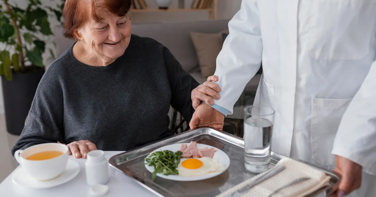 Parkinson disease management where doctor supporting elderly patient with healthy diet for Parkinson’s care.