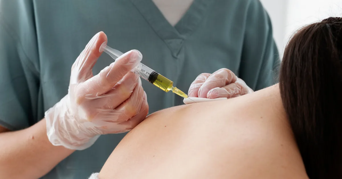 Doctor injecting Botox for muscle weakness in Parkinson's patient’s back