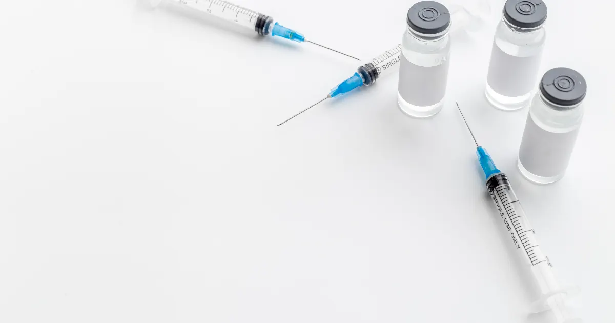 Botox vials and syringes on a white surface, representing Botox treatment options for CBD patients.