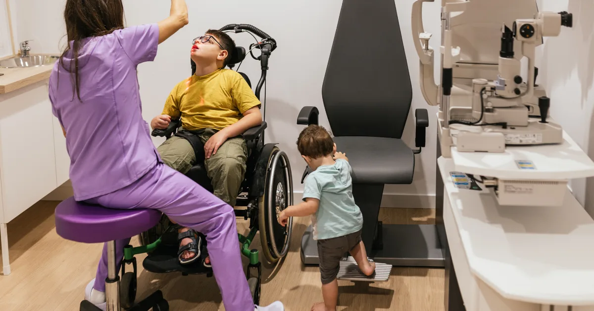 Healthcare professional examining a child in a wheelchair, representing PSP treatment and supportive care approaches