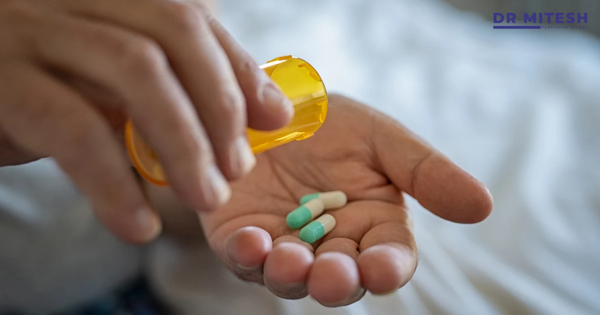 Capsules poured into a patient’s hand representing medications that can cause Drug Induced Movement Disorders as a side effect.