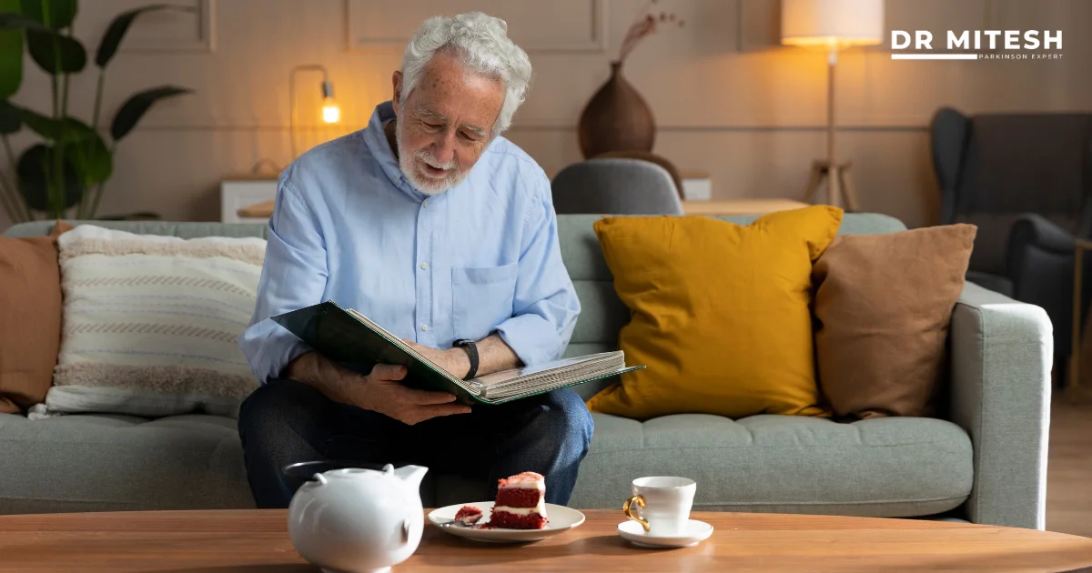 Elderly man reading at home showing how people with Parkinson’s can live independently