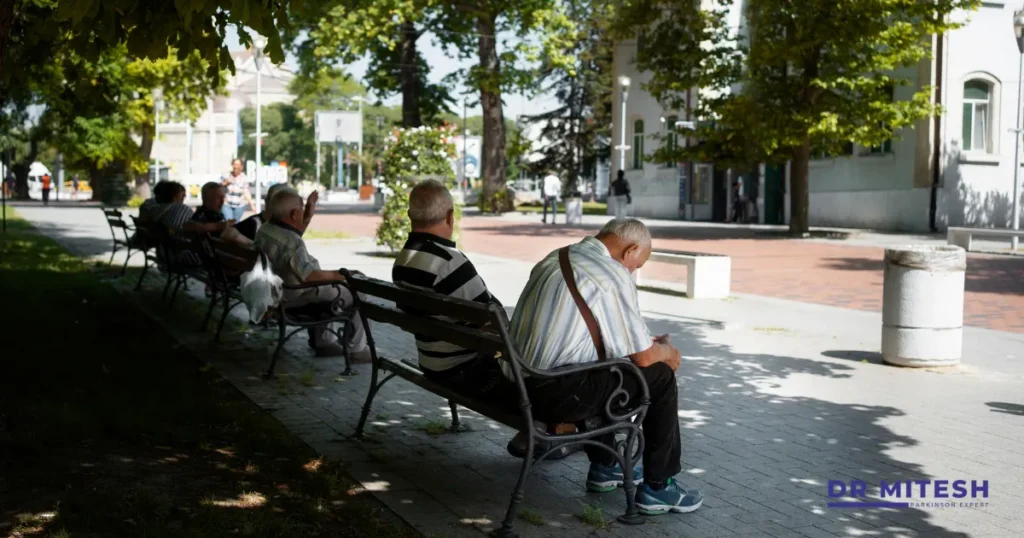 Elderly people sitting in public places highlighting mobility and comfort challenges in Parkinson’s